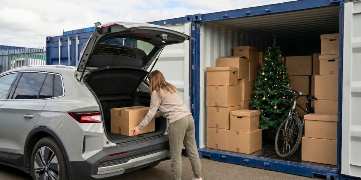 A woman storing away Winter Storage items like a Christmas tree and decorations